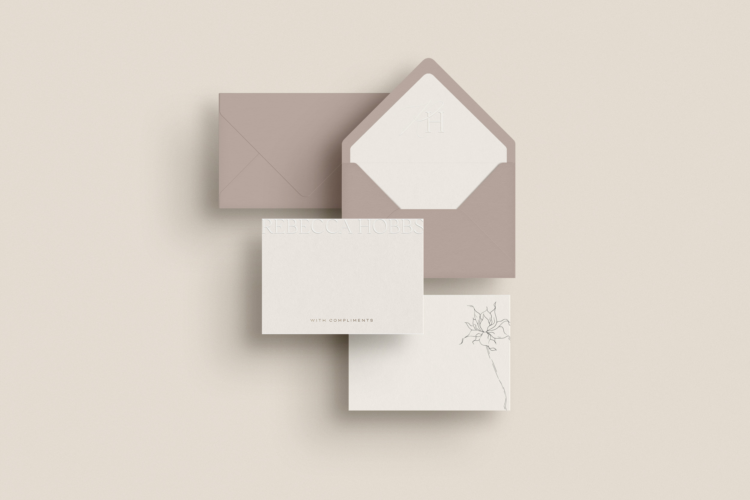 A flat lay of stationery in taupe colours