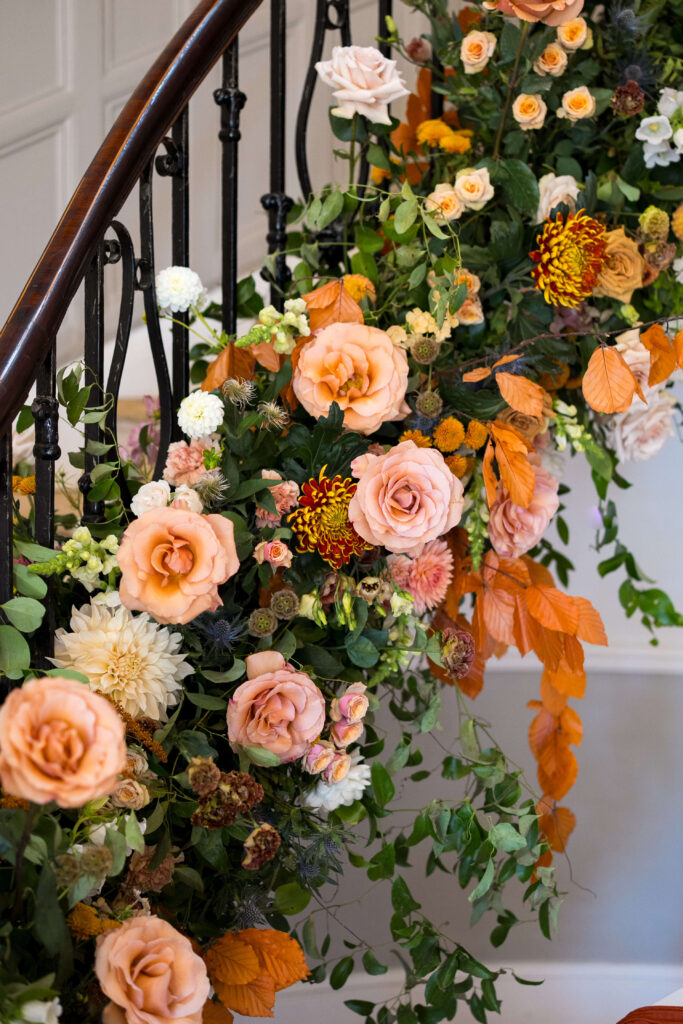 Floral staircase at Eastington Park in nudes, taupe, brown and toffee coloured flowers