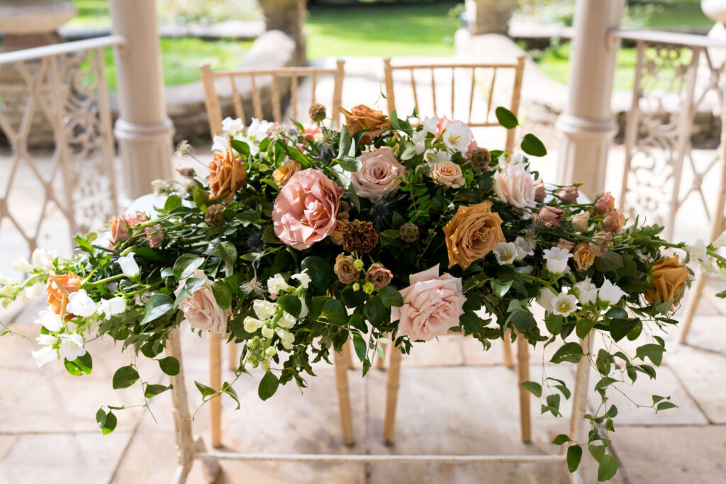 Ceremony table flowers in Autumn colours at Eastington park