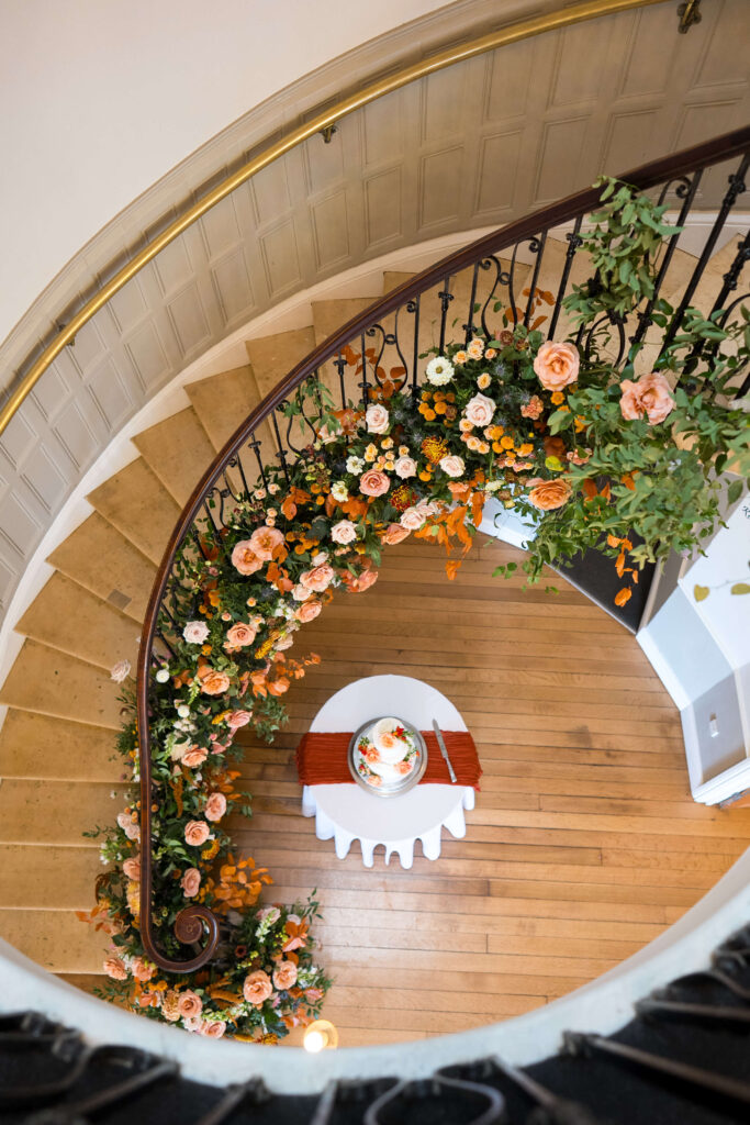 Floral staircase at Eastington Park in nudes, taupe, brown and toffee coloured flowers