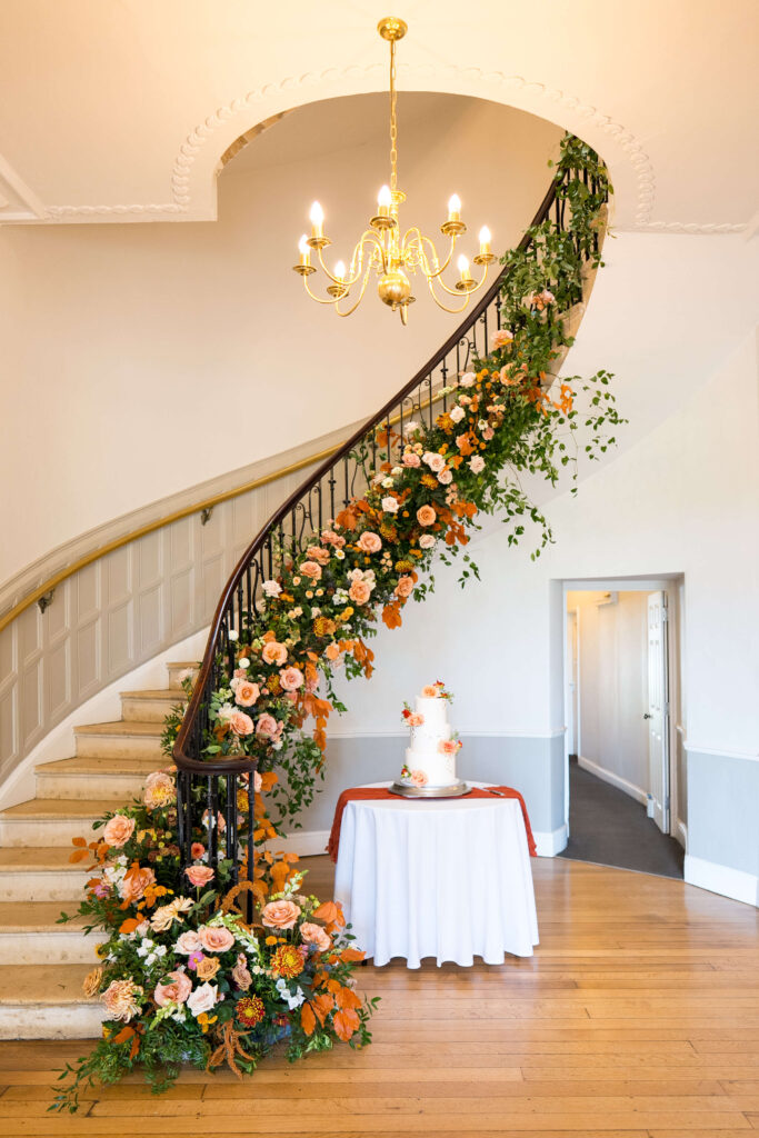 Floral staircase at Eastington Park in nudes, taupe, brown and toffee coloured flowers